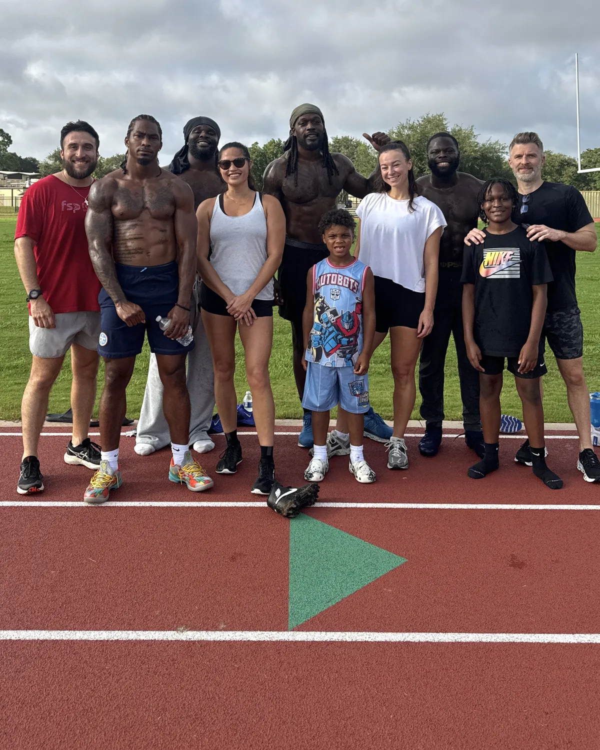 Professional athletes and the Unify PT team together on the track at Fairchild Sports Performance